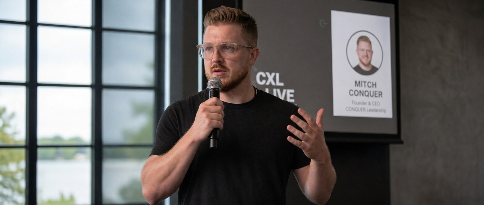 Mitchell Conquer speaking on stage